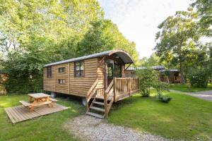 a log cabin with a wooden deck and a picnic table at CityKamp Paris in Paris