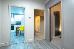 a hallway with a mirror and a dining room at Brattan House Oxton Wirral 5 bedroom 3 bathroom with on-street parking ideal for vans by Rework Accommodation in Birkenhead