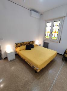 a large bed in a room with two windows at La Mimosa in Rapallo