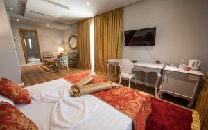 a hotel room with a bed and a desk at Classic Hotel in Tirana