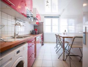 a kitchen with a sink and a table with chairs at The Beauty of Venice in Paris