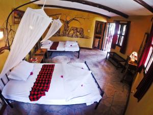 an aerial view of a bedroom with two beds at NSYA CAMP MANYARA in Mto wa Mbu +1 photo