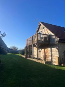 a house with a deck on the side of it at Highcroft House in Corsham
