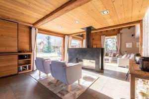 a living room with chairs and a fireplace at Chalet Alpen in Praz-sur-Arly