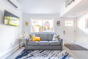 a living room with a couch and a window at Cute as a Button! in Seattle