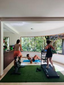 a group of people exercising on treadmills in a room at Mama Tungu hostel in Baños