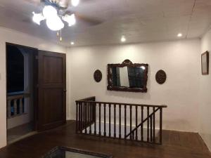 um corredor com uma escada e um espelho na parede em Heart of Paete Laguna, Camarero Transient House em Paete