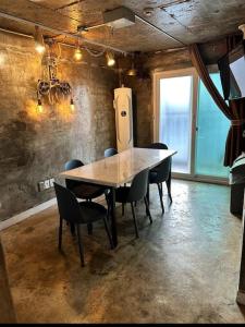 a dining room with a table and chairs and a window at How are you here in Hongdae in Seoul
