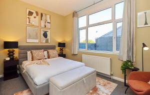 a bedroom with a bed and a large window at The Crystal Palace Crib - Lovely 1BDR Flat in Crystal Palace