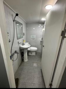 a small bathroom with a toilet and a sink at How are you here in Hongdae in Seoul