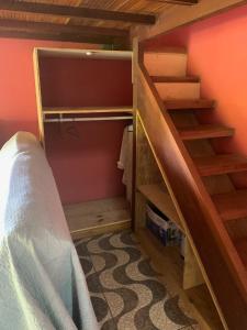 a bedroom with a bunk bed and a staircase at La Maison Cocobanana in Itacaré