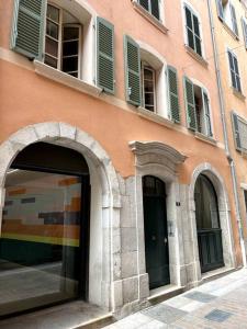 a building with green shutters on the side of it at Appartement standing pour 4 in Toulon +3 photos