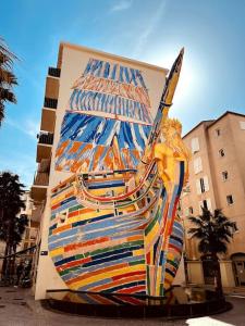 a large painting of a ship on the side of a building at Appartement standing pour 4 in Toulon