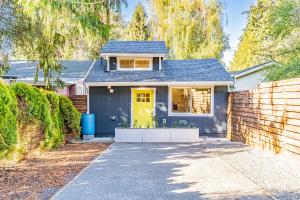 a small blue house with a yellow door at Cute as a Button! in Seattle