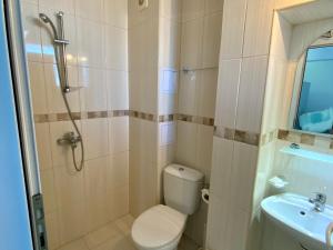 a bathroom with a toilet and a sink at Sea View Rooms Briz in Nesebar