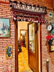 a door to a store with a christmas decoration on it at Hotel British House in Tbilisi City