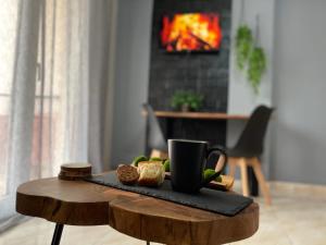 a table with a tray of bread and a coffee cup at R&K MODERN APARTMENT in Xanthi