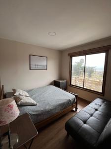 a bedroom with a bed and a large window at Moderna Casa - Playa Puertecillo in Navidad