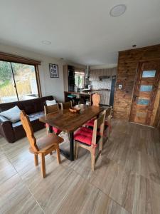 a dining room with a wooden table and chairs at Puertecillo Surf Paradise - Primera Línea al Mar in Navidad