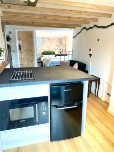 a kitchen with a counter top with a stove top oven at The Walkers' Cwtch in Ffestiniog