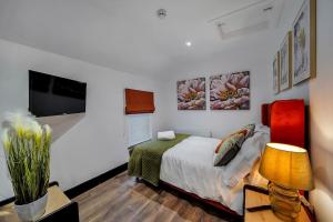 a bedroom with a bed and a table with a lamp at The Eden Loft: A Stylish Retreat in Strabane