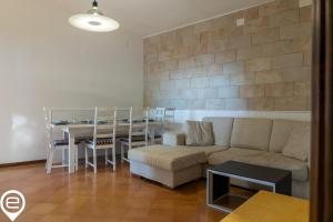 a living room with a couch and a table at Alghero Sea Whisper in Fertilia
