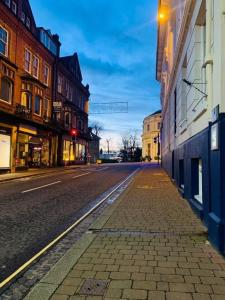 an empty city street with buildings and a street light at Great Malvern Hotel in Great Malvern