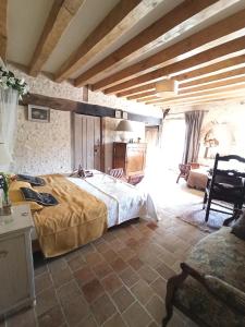 ein Schlafzimmer mit einem großen Bett in einem Zimmer in der Unterkunft LE BONHEUR DES HÔTES in Suèvres
