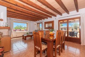 a dining room with a wooden table and chairs at Villa Els Amatllers by Sealand Villas in Port de Pollensa