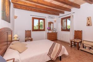 a bedroom with a large bed and two windows at Villa Els Amatllers by Sealand Villas in Port de Pollensa +39 photos