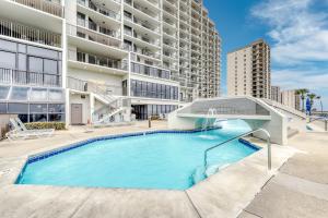 a swimming pool in front of a building at Phoenix VI 807 in Orange Beach