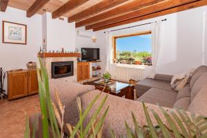 a living room with a couch and a fireplace at Villa Els Amatllers by Sealand Villas in Port de Pollensa