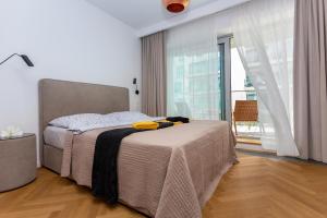 sypialnia z łóżkiem i dużym oknem w obiekcie Yacht Park Marina w mieście Gdynia