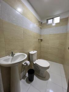 a bathroom with a toilet and a sink at Gianina house in Barranquilla