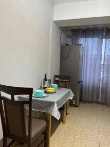 a dining room table with two chairs and a refrigerator at Apartment for relax in Chişinău