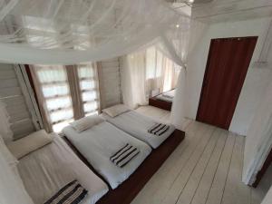 a large bed in a room with a window at Wabi Sabi House Broga in Semenyih