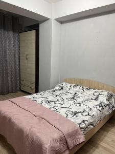 a bedroom with a bed and a dresser at Apartment for relax in Chişinău