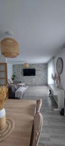 sala de estar con sofá y reloj en la pared en Maison individuelle avec jardin, en Vaujours