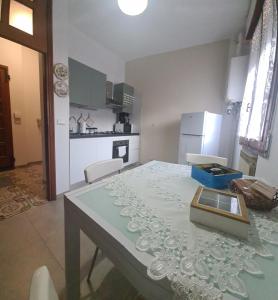 a kitchen with a table with a table cloth on it at Apartament Cedro del Libano in Marano