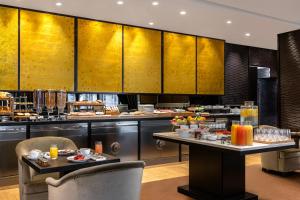 a restaurant with a buffet line with food on tables at Hyatt Paris Madeleine in Paris