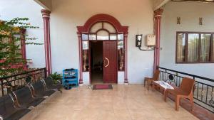 an entrance to a house with a red door at OYO 93176 Hotel Savira in Barru