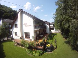 a white building with a garden in front of it at Mosel-Pension Gästehaus Christiane, Brodenbach in Brodenbach