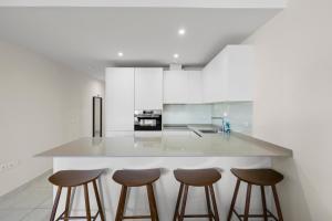 a kitchen with a counter with four stools at Stunning Apt in Mijas by Costarentals - Ref 235 in Mijas Costa