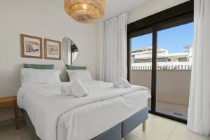 a bedroom with a large bed and a large window at Stunning Apt in Mijas by Costarentals - Ref 235 in Mijas Costa +25 photos