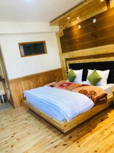 a bedroom with a large bed with wooden walls at Spiti Valley Hotel in Kaza