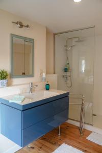 a bathroom with a sink and a shower at De Koetsier in Lanaken