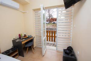 a room with a desk and a sliding glass door at Trendy Studios with FREE PARKING in Veliko Turnovo in Veliko Tŭrnovo