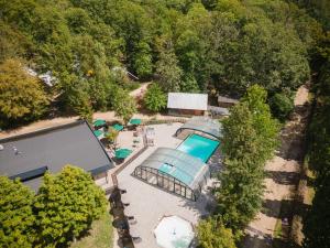 an overhead view of a swimming pool and trees at Huttopia Versailles in Versailles