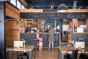 two women and a little girl standing at a bar at Huttopia Versailles in Versailles +25 photos
