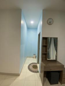 a hallway with a clock on the wall and a tile floor at DD Homestay Pasir Gudang in Pasir Gudang